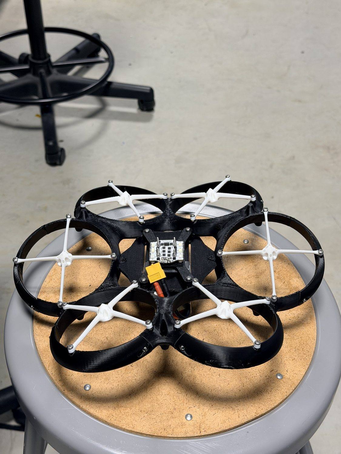 The drone mid-build, bare airframe with the flight controller exposed