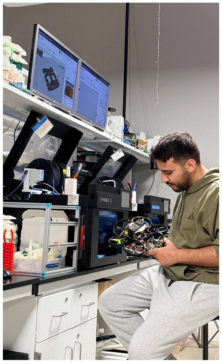 Farbod holding the finished hexacopter in the lab
