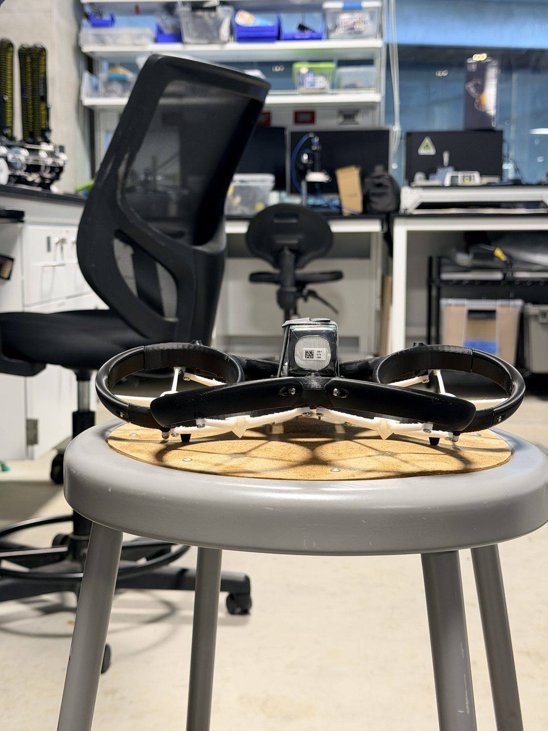 The bare hexacopter airframe head-on, on a stool in the lab