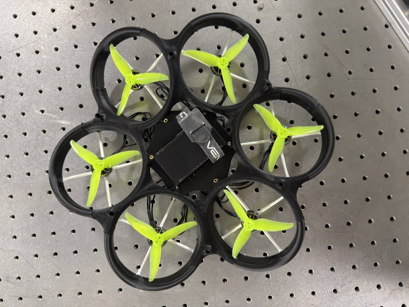 Top-down view of the hexacopter with green flight props on the optics bench